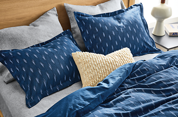 detail of zada duvet and shams in indigo on bed.